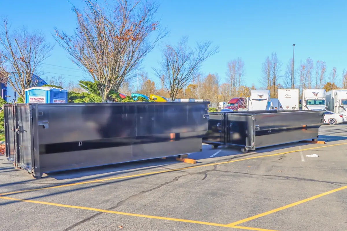 Professional dumpster rental service with roll-off container on residential driveway in Cranberry